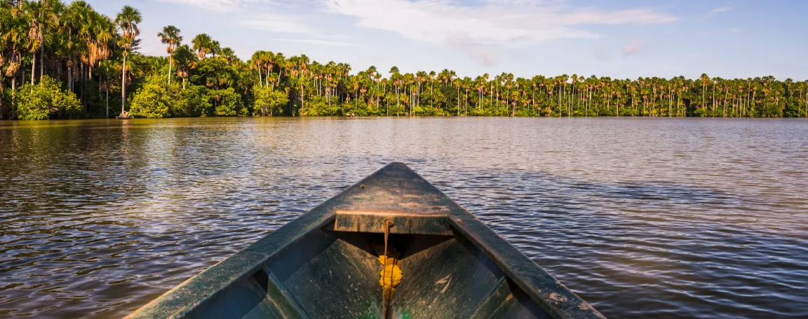 Canoe boat trip on Sandoval Lake Tambopata National Reserve Amazon Jungle of Peru South America