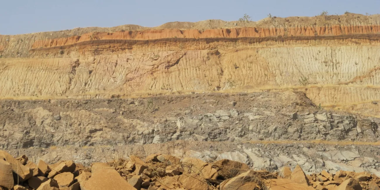 Mining pit. It is easy to distinguish the different soil horizons, including the A horizon washed red and the darker B horizon which is an area of salt and mineral accumulation typical of tropical soils.